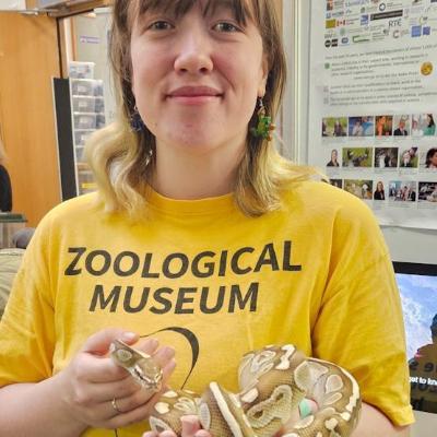 Zoological Museum Volunteer holding small yellow snake